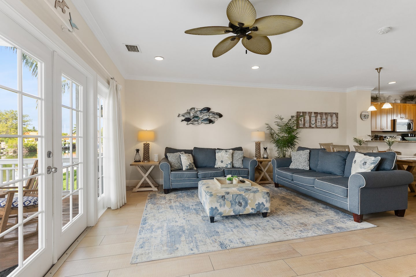 Bright living room with sectional sofa and doors to the porch